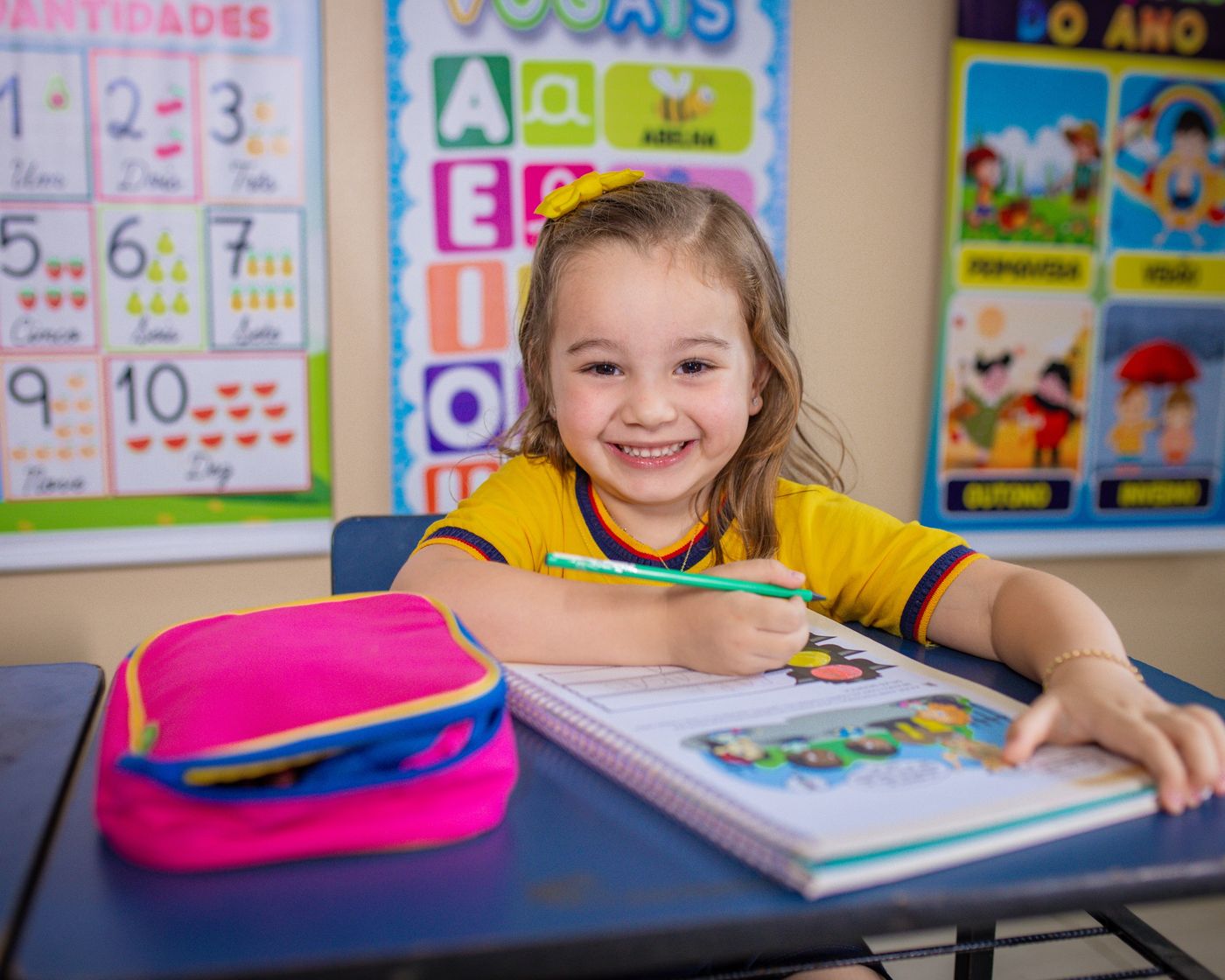 Criança da Educação Infantil sorrindo em sala de aula